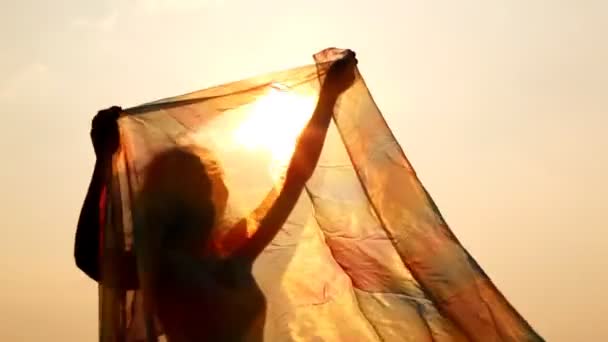 Woman has hold thin shawl which waves on wind — Stock Video