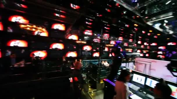 People sit near control panel at club — Stock Video