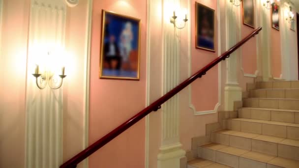 Interior with lanterns and pictures on wall and staircase upwards — Stock Video