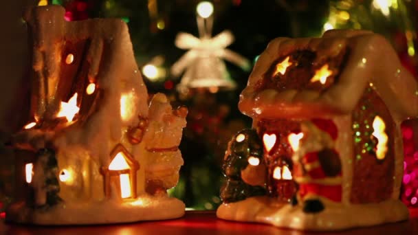 Toy house-candlestick stand at background of christmas tree ornaments