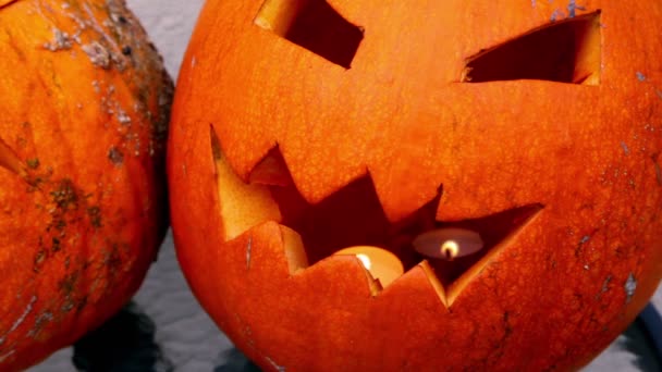 Scary Jack O-Lantern halloween pumpkin with flaming candle inside — Stock Video