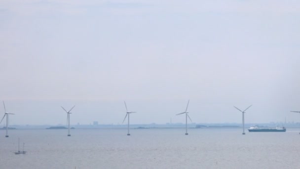 Wind farms stationed on water in front of Copenhagen, time lapse — Stock Video