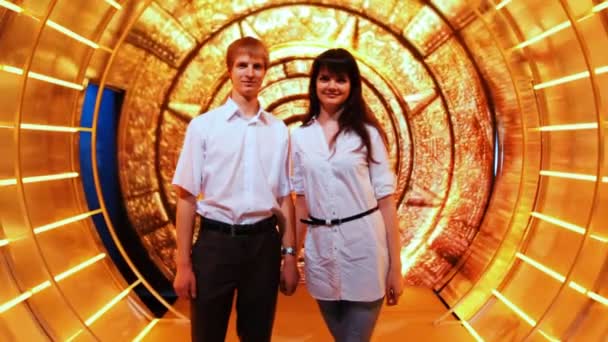 Couple stands holding hands in fabulous decoration tunnel — Stock Video