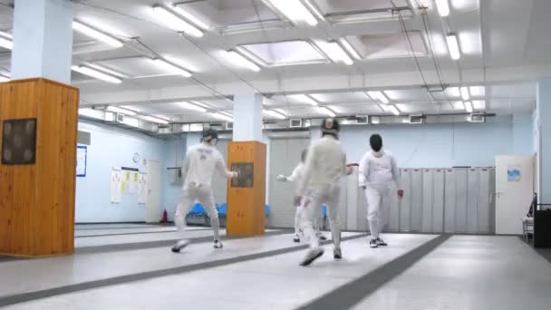 Four fencers train in sports hall of Dynamo club — Stock Video