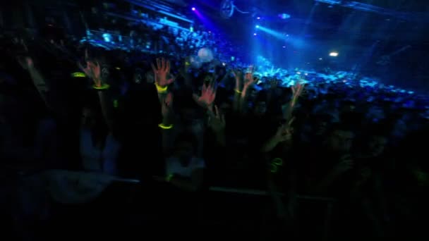 Spectators stand behind fencing at Armin Only show in concert hall — Stock Video