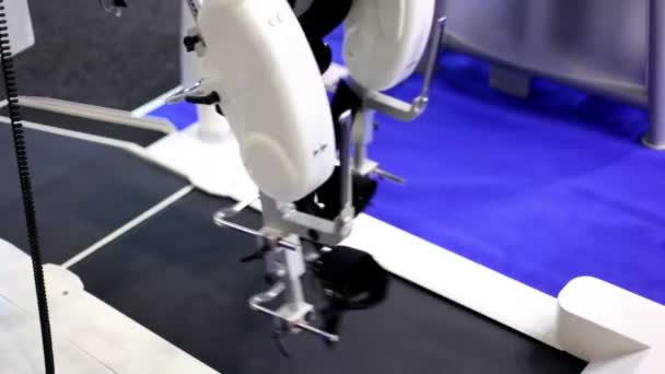 Robotic prosthetic legs moves above working racetrack — Stock Video