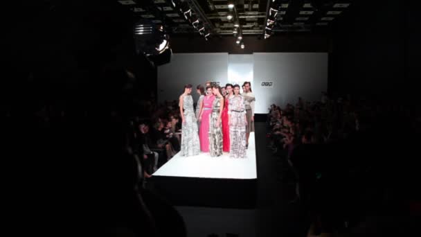 Many models in dresses from Liliya Pustovit collection, walk away on podium — Stock Video