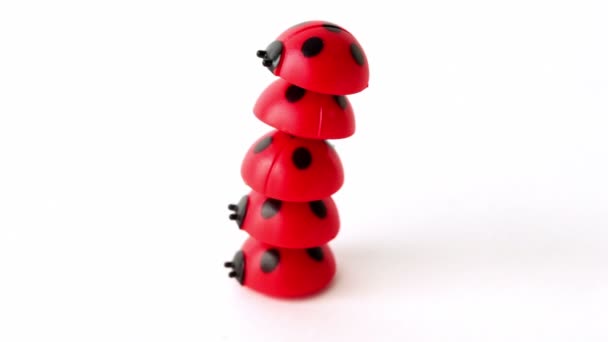 Five toy ladybugs lay one on one — Stock Video