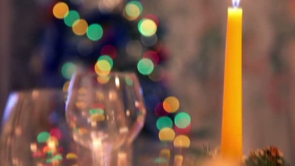 Candles and glasses on decorated christmas dining table — Stock Video