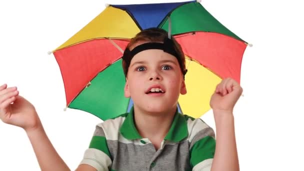 Boy in cap as umbrella rainbow colors fun pretend that hiding from rain — Stock Video