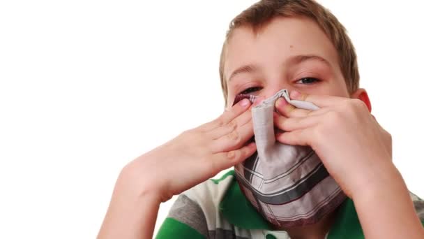 Affected by cold boy wipes his nose with handkerchief and sneezes — Stock Video