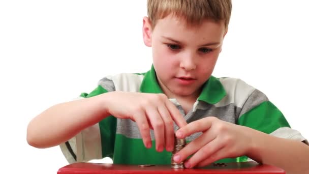 Boy on red base puts coins in higher column — Stock Video