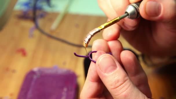 The process of soldering plastic ring, only hands are visible — Stock Video