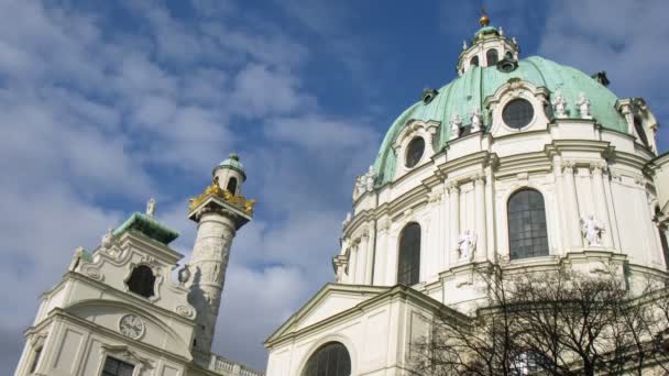 Towers of Karlskirche Church stand against floating clouds — Wideo stockowe