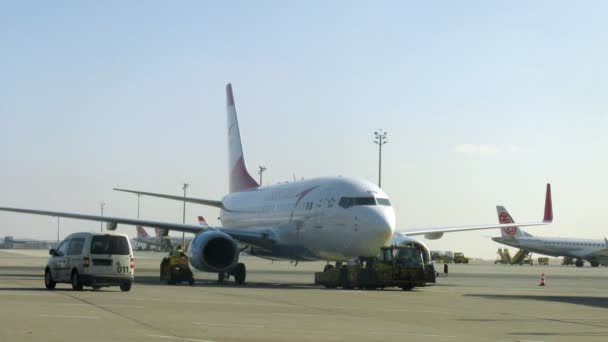 Mechanics board do maintenance inspection of plane and move it on parking space — Stock Video