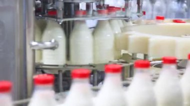 taze süt şişesi dökülür, kırmızı kapaklar vidalı ve tüketiciler için göndermek