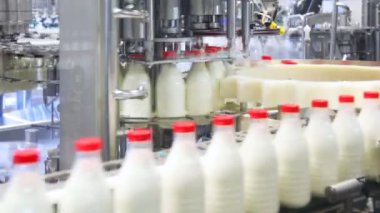 taze süt şişesi dökülür, kırmızı kapaklar vidalı ve tüketiciler için göndermek