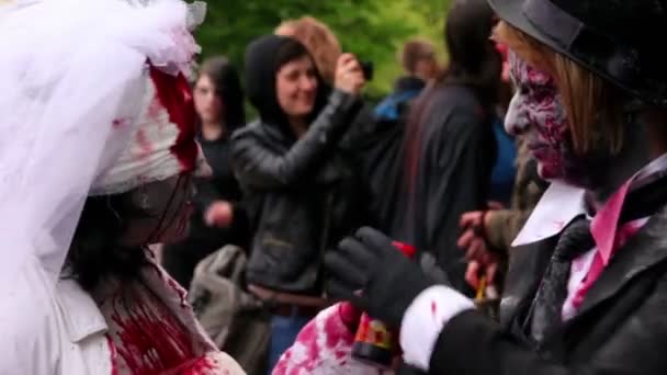 Bloody zombies newlyweds talk closeup during Zombie Parade — Stock Video