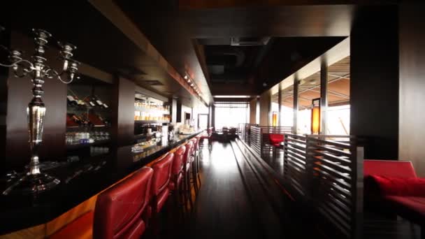 Chairs near to bar and little tables for two stand in long lounge of restaurant — Stock Footage Chairs near to bar and little tables for two stand in long lounge of restaurant Royalty Free Stock Footage