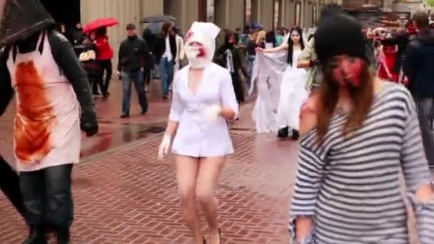 Zombie nurse walk along street in bloody bandage during Zombie Parade — Stock Video