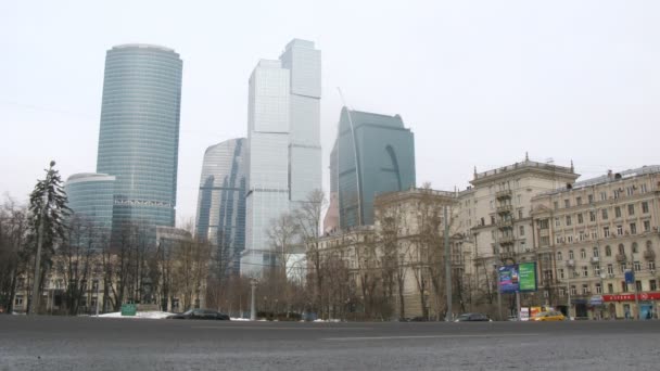 Cars goes on prospectus before center Moscow City and Stalin house stand on right — Stock Video