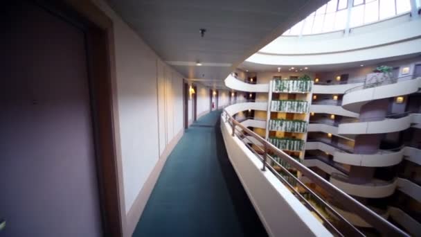 Little girl runs along balcony at top level of multiple floor building — Stock Footage Little girl runs along balcony at top level of multiple floor building Royalty Free Stock Video