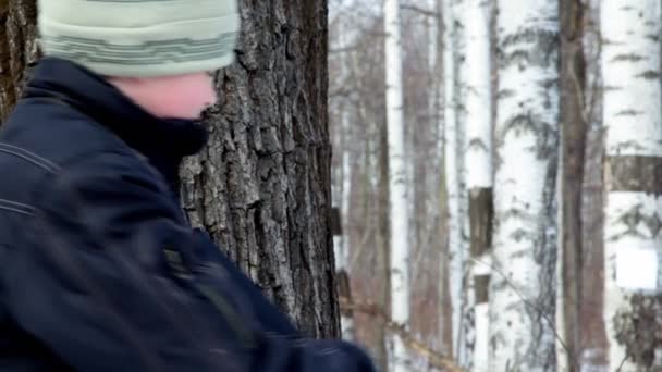 Young boy shoots paper target on birch — Stock Video