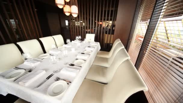 Decorated table for ten persons stands in corner of hall of restaurant — Stock Video