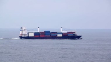 Büyük kargo gemisi dolu kaplar yüzen deniz dalgaları üzerinde