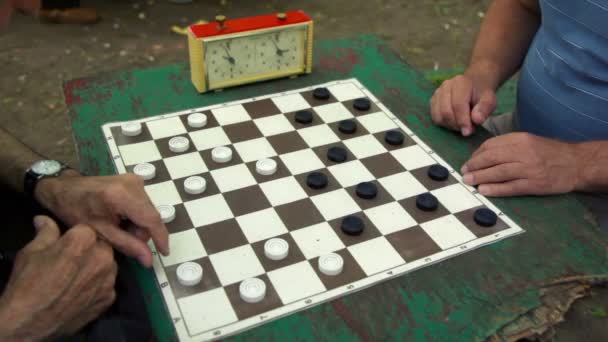 People play checkers with time limit, and then girl cames — Stock Video