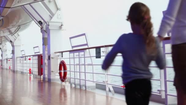 Mother and her daughter walk by deck near fence during cruise — Stock Video