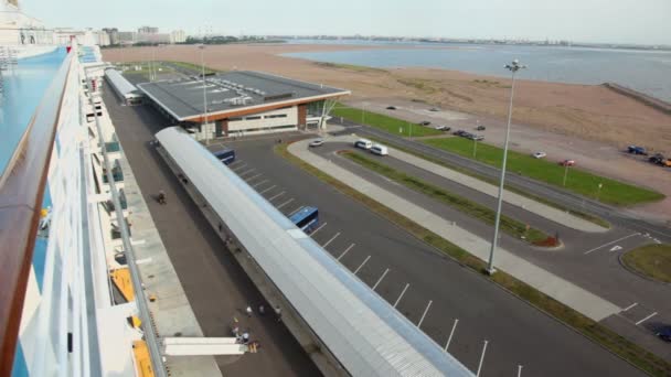 Deck of liner on moorage in port with beach and cityscape far — Stock Video