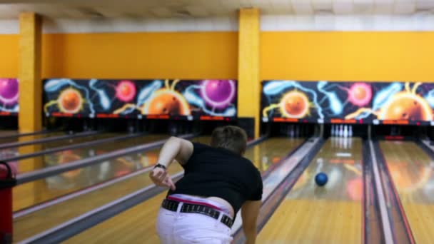 Jongen gooit bowling bal en vervolgens dansen blij met resultaat — Stockvideo