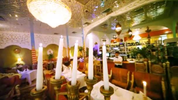 Candlestick bear and put on decorated table at restaurant — Stock Video