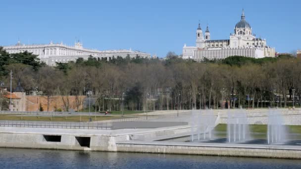 Almudena Cathedral stands near river and fountain, time lapse — Stock Video