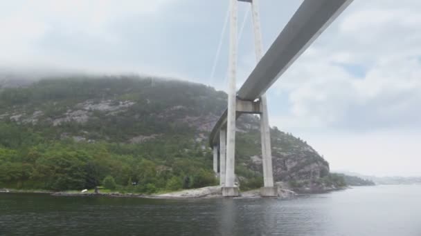 Huge pendant bridge at coast with forest on mountains — Stock Video