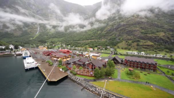 Kleiner Hafen mit Häusern und Eisenbahn in einer Mulde zwischen Bergen — Stockvideo