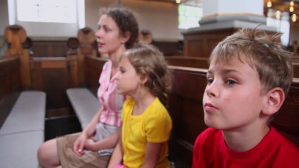 Kids speak with mother about religion when they sit in church — Stock Video
