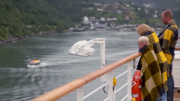 Родители с сыном стоят завернутые в одеяло на борту корабля — стоковое видео