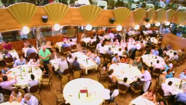 Many people sit at tables in restaurant on ship during cruise — Stock Video