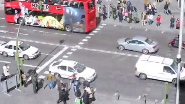 People go on Gran Via street on crosswalk — Stock Video