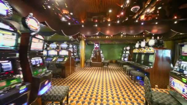 Motion through empty casino with lot of play machines around — Stock Video