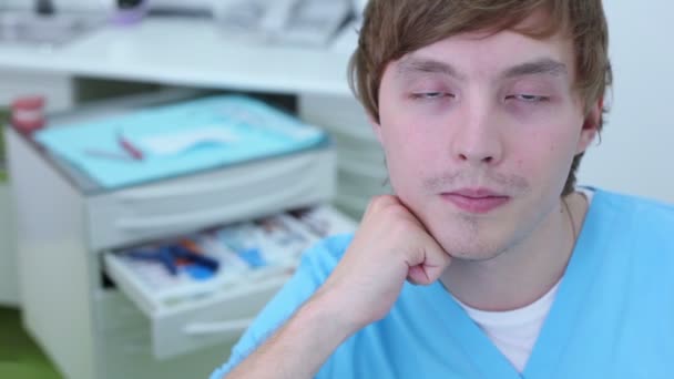 Visage de l'infirmière garçon sourit en chirurgie dentaire, vue rapprochée — Video