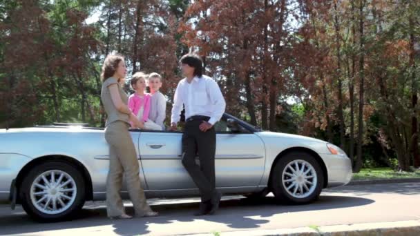 Parents speak near cabriolet and kids listen them inside car — Stock Video