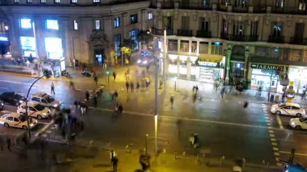 People go on crosswalk on Gran Via Street at night — Stock Video