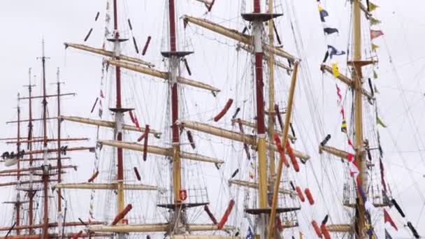 Masts of sailing ships stand with collected sails and flags — Stock Video