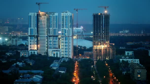 Evening cityscape of construction site among houses — Stock Video