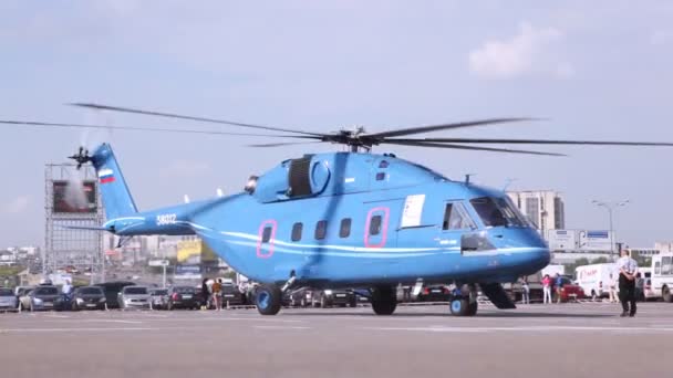 Helicopter stands on take-off platform at exhibition — Stock Video