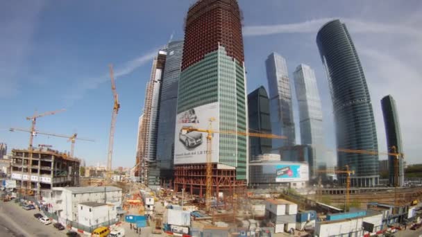 Cars go near building Moscow City business center in afternoon — Stock Video