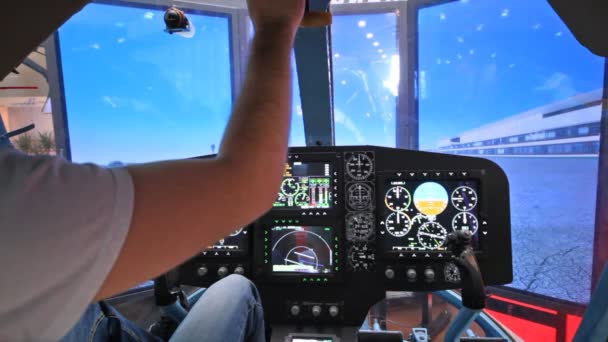 Pilot operates helicopter simulator during take-off — Stock Video